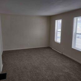 spare room featuring dark carpet