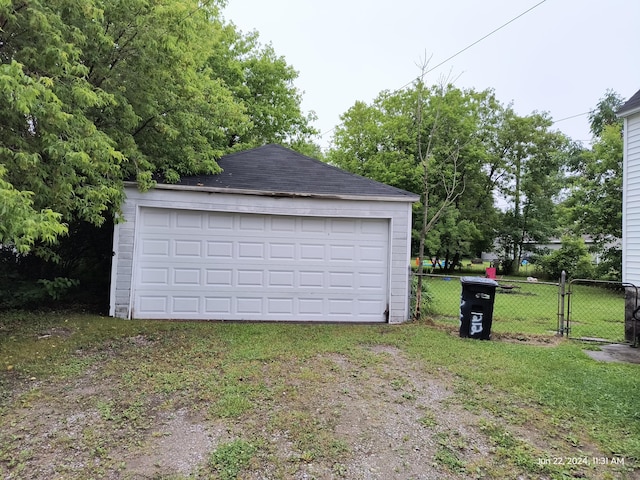 garage featuring a lawn