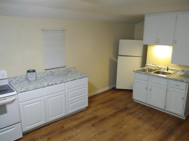 kitchen featuring white cabinets, sink, white appliances, and dark hardwood / wood-style floors