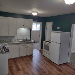 kitchen featuring sink, white cabinetry, white appliances, and dark hardwood / wood-style floors