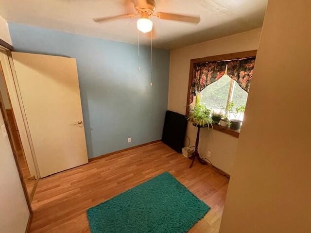 bedroom with light hardwood / wood-style floors and ceiling fan