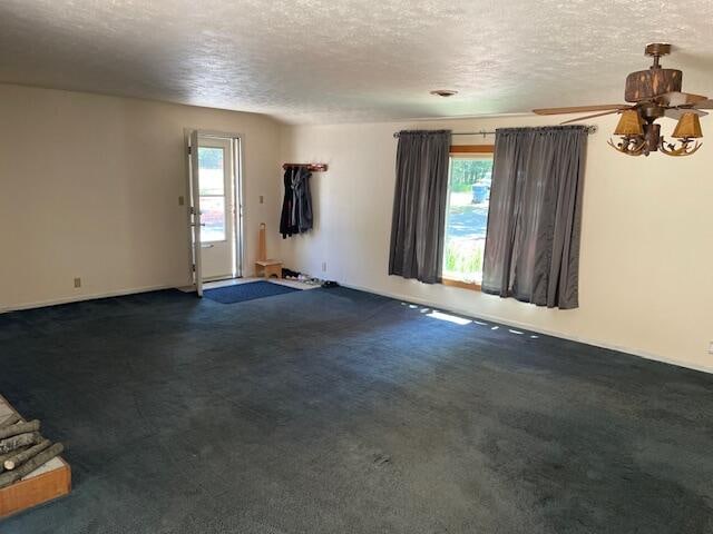 interior space featuring a textured ceiling and ceiling fan