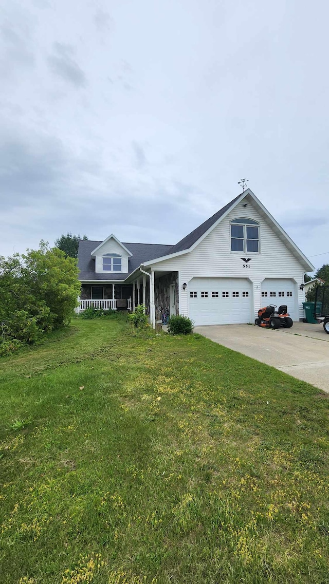 view of front of home with a garage and a front lawn