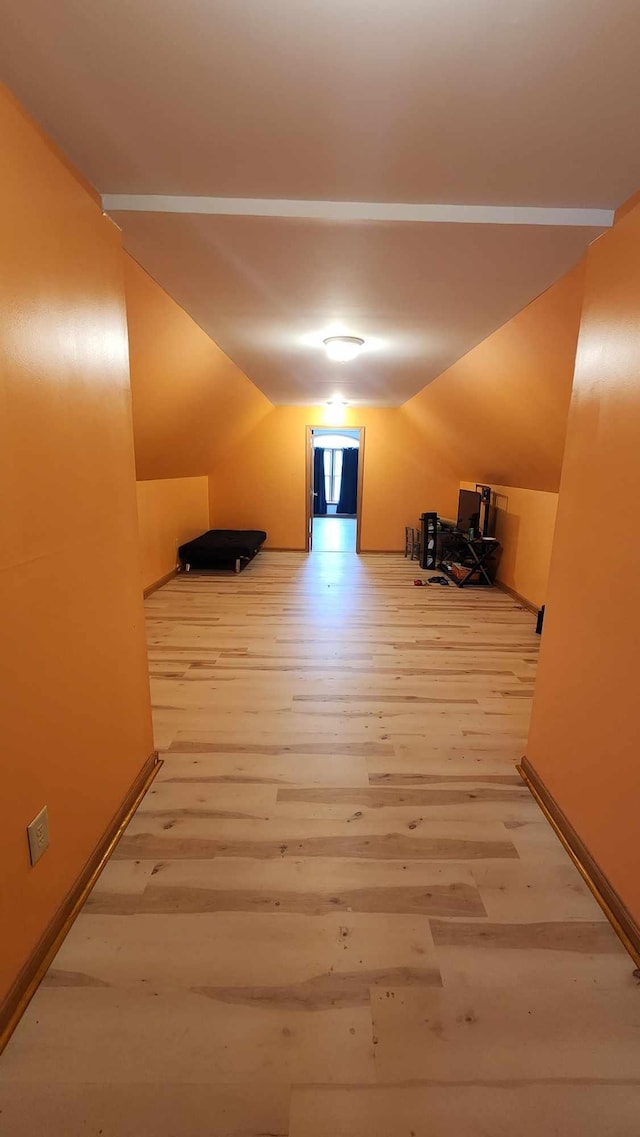 bonus room featuring lofted ceiling and wood-type flooring