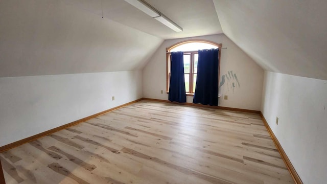 bonus room with lofted ceiling and hardwood / wood-style flooring