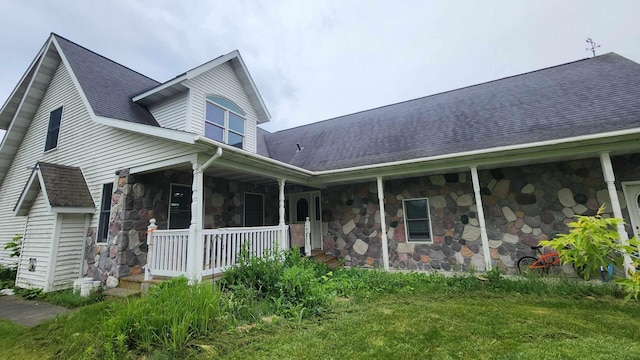 exterior space featuring a porch and a yard