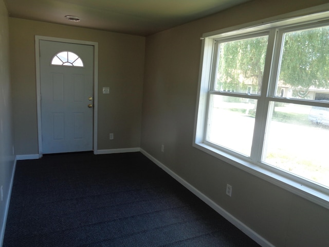 foyer with dark colored carpet