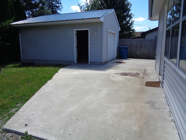 view of outdoor structure with a lawn and a garage