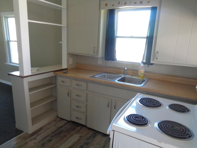 kitchen featuring stove, dark hardwood / wood-style flooring, sink, white cabinets, and plenty of natural light