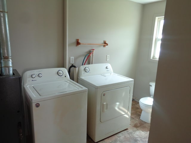 clothes washing area with washer and dryer