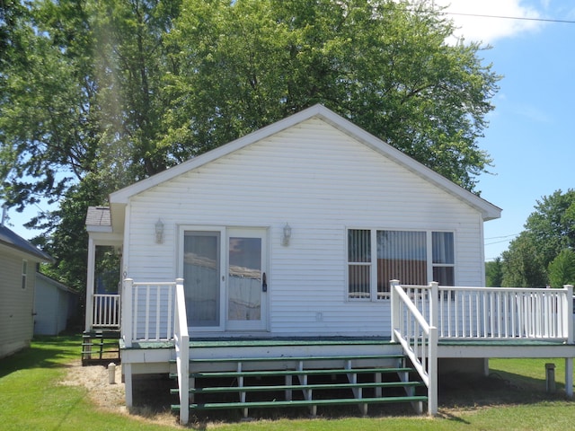 rear view of house featuring a wooden deck