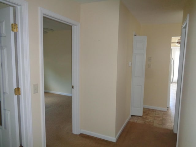 hall with light colored carpet