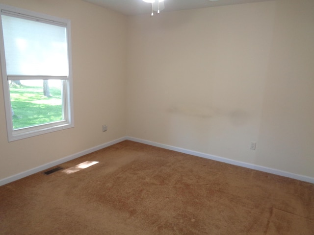 spare room featuring carpet and ceiling fan