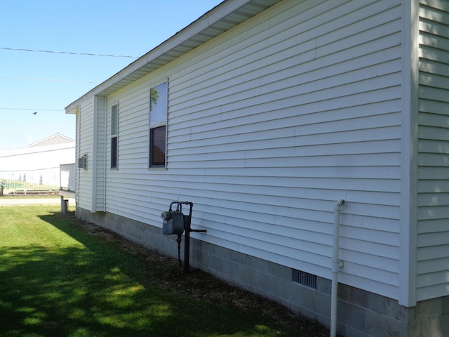 view of side of home featuring a yard