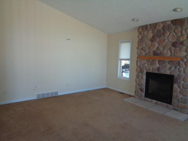 unfurnished living room featuring carpet flooring and a stone fireplace