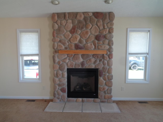 room details with carpet flooring and a stone fireplace