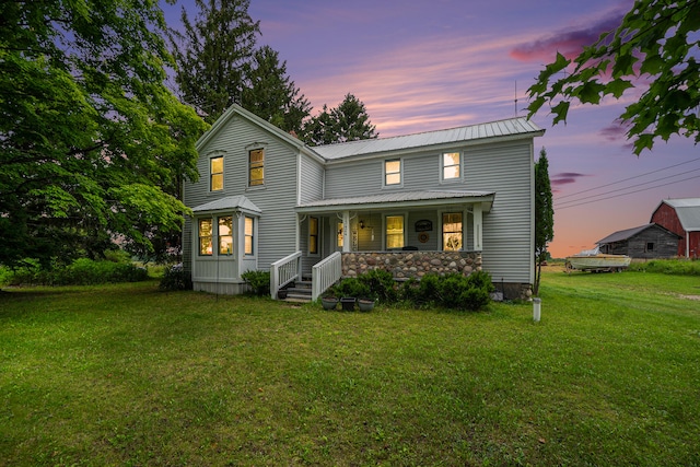 view of front facade with a porch and a yard