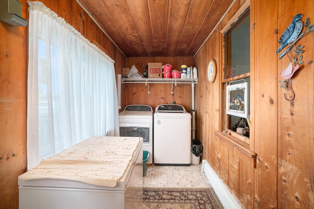 laundry room featuring wood ceiling, washer and clothes dryer, wooden walls, and light tile patterned floors