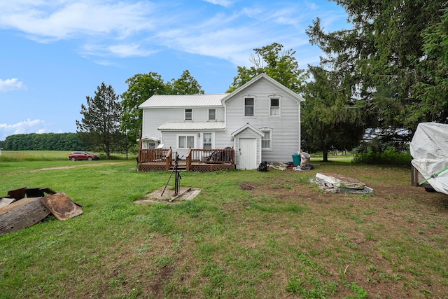 rear view of house with a yard and a wooden deck