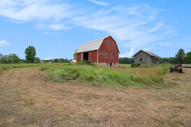 exterior space with an outbuilding and a rural view