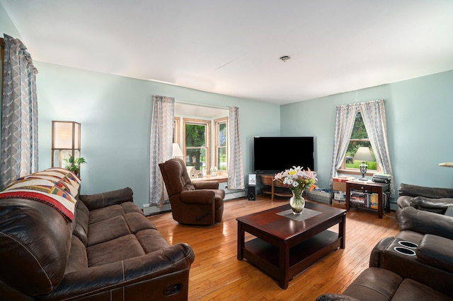 living room featuring baseboard heating and wood-type flooring