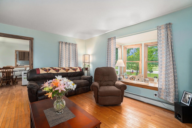 living room featuring light wood-type flooring and baseboard heating