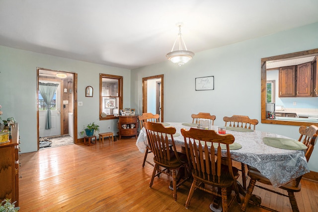 dining space with light hardwood / wood-style flooring