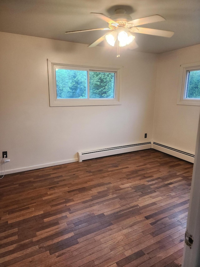 spare room with a baseboard radiator, ceiling fan, and dark wood-type flooring