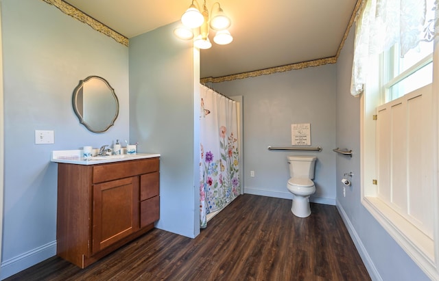 bathroom featuring a shower with shower curtain, vanity, hardwood / wood-style flooring, an inviting chandelier, and toilet