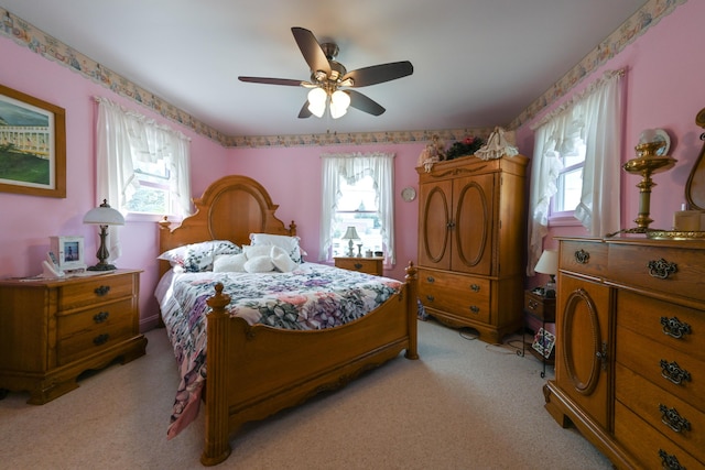 bedroom featuring ceiling fan and light carpet