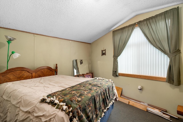 bedroom with lofted ceiling, carpet floors, and a textured ceiling