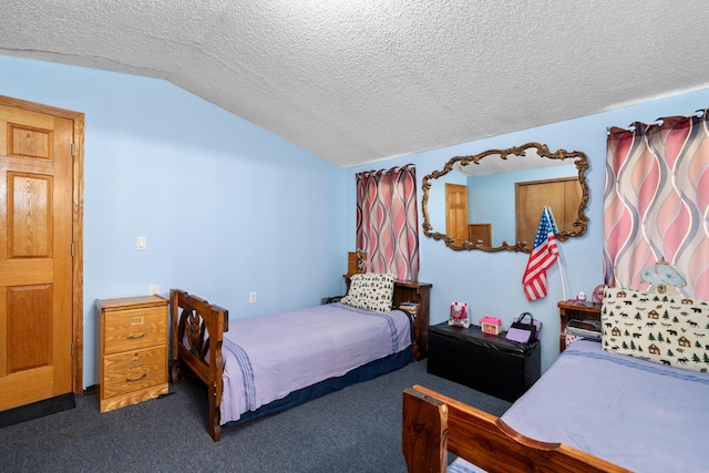 bedroom featuring dark carpet, vaulted ceiling, and a textured ceiling