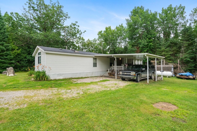 view of front of property with a carport and a front yard