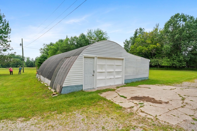 garage featuring a lawn