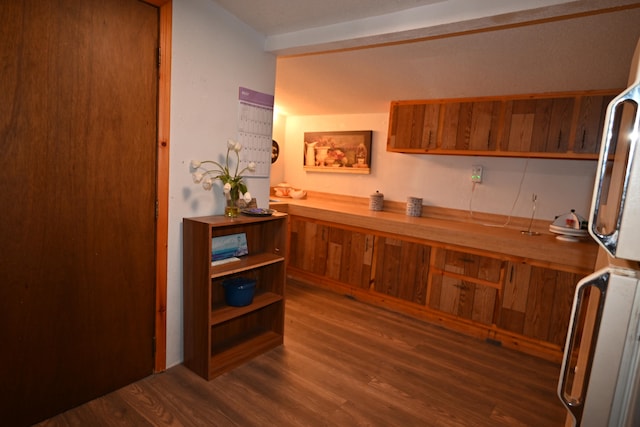 interior space featuring fridge and dark hardwood / wood-style flooring