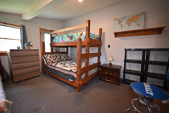 bedroom featuring carpet floors and beam ceiling