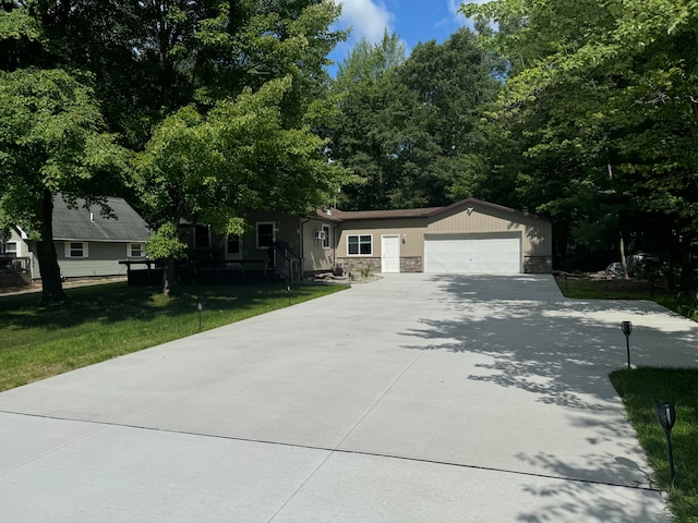 view of front of house with a garage and a front lawn