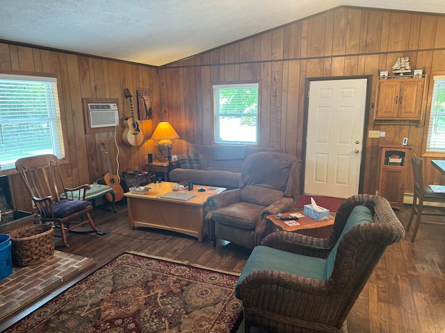 living room featuring an AC wall unit, vaulted ceiling, a textured ceiling, and dark hardwood / wood-style flooring