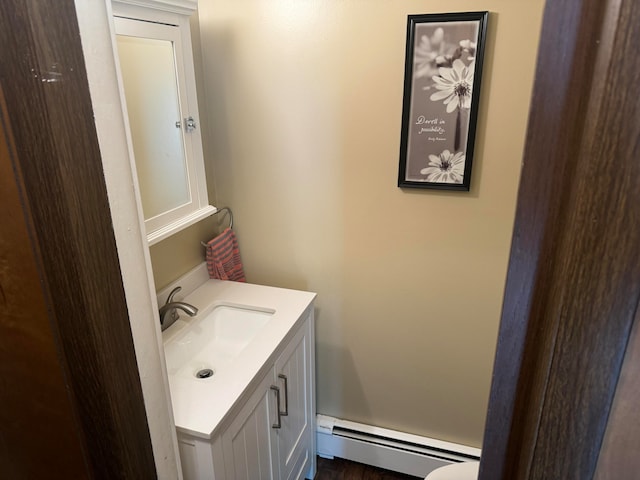 bathroom with vanity and a baseboard heating unit