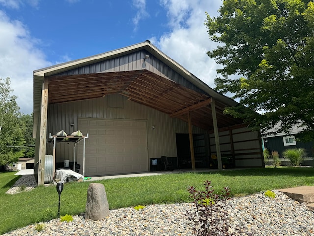 view of outbuilding with a garage and a lawn