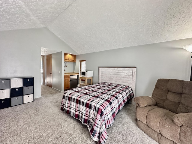 bedroom featuring vaulted ceiling, light colored carpet, fridge, and a textured ceiling