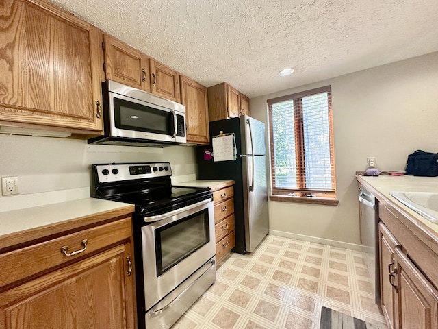 kitchen featuring a textured ceiling and stainless steel appliances