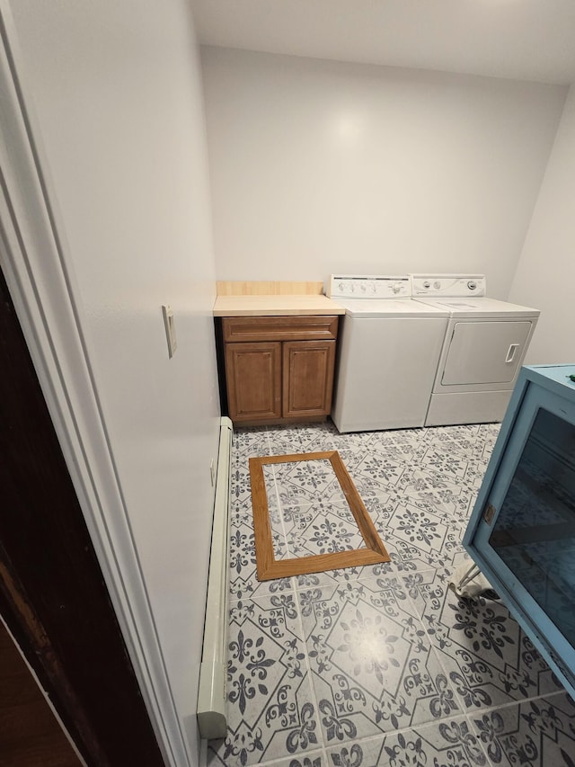 washroom with cabinets, separate washer and dryer, and light tile patterned floors