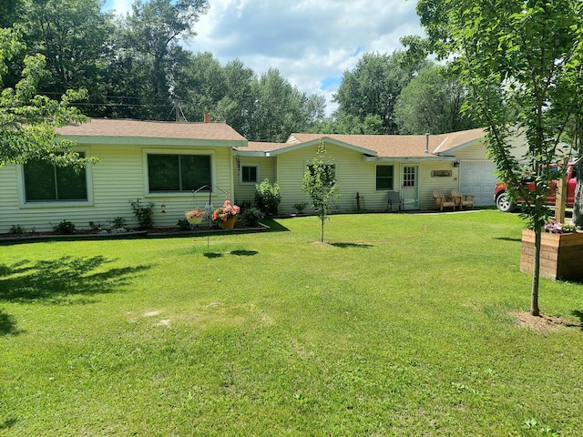 exterior space featuring a garage and a front lawn