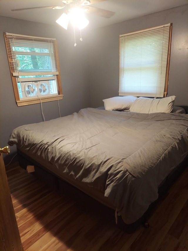 bedroom with wood-type flooring and ceiling fan