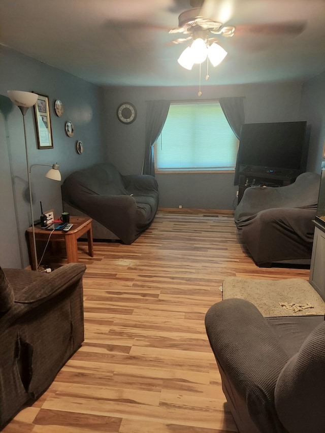 living room featuring ceiling fan and light wood-type flooring