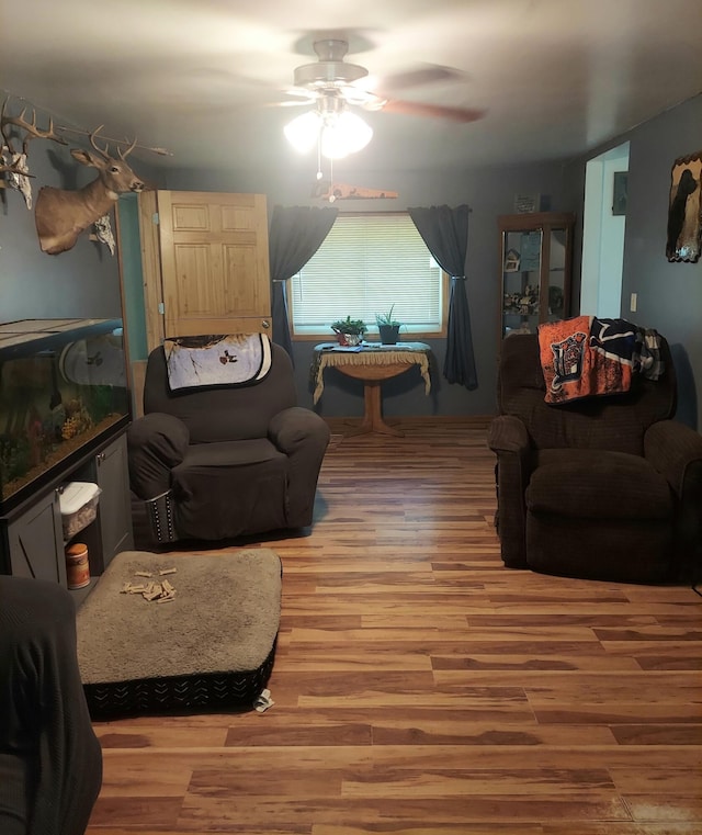 living room with ceiling fan and wood-type flooring