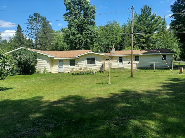 rear view of property featuring a yard