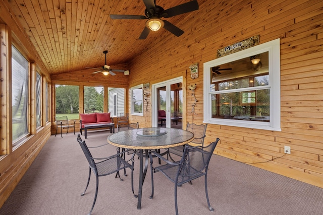 sunroom featuring ceiling fan, a wealth of natural light, lofted ceiling, and wood ceiling