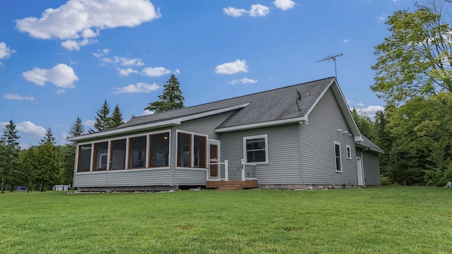 back of house featuring a sunroom and a yard